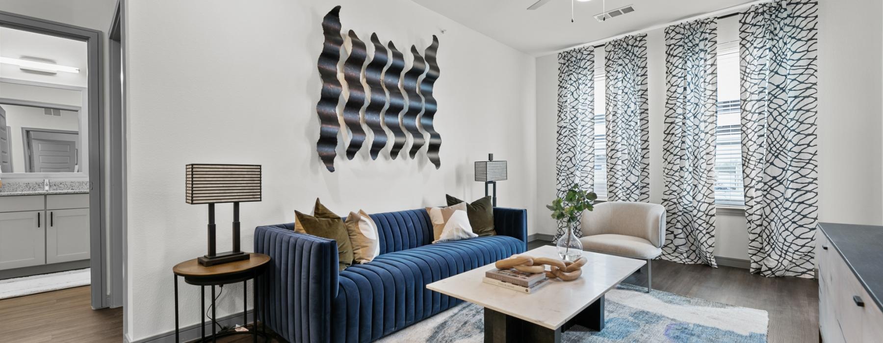 a living room with a blue couch and a table