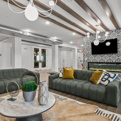 a living room with a large tv and couches