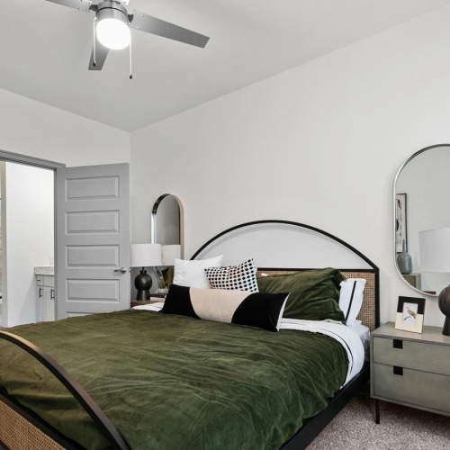 a bedroom with a bed and a mirror